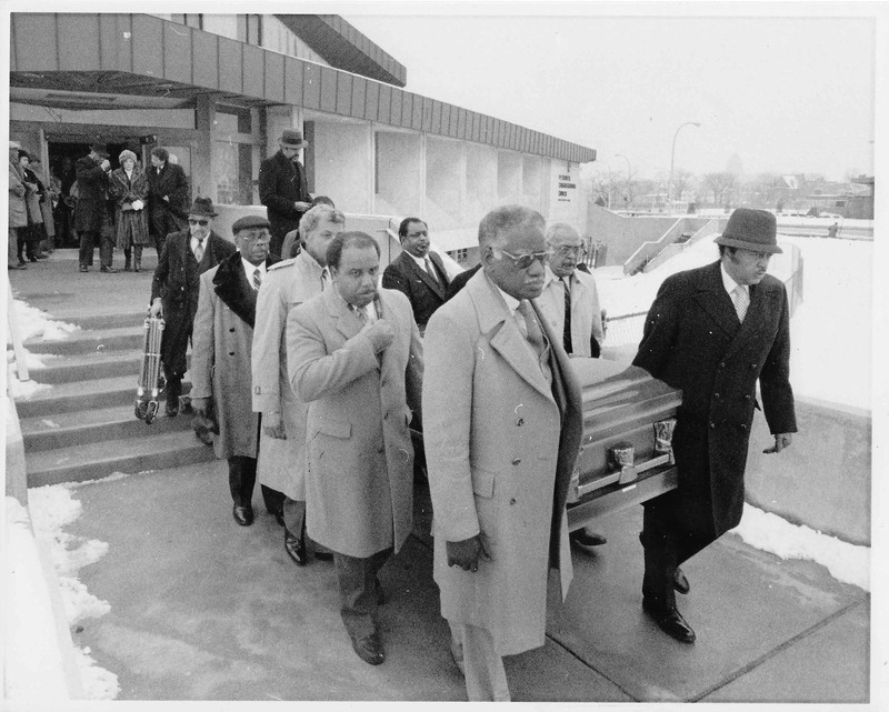 Pallbearers carrying the casket at the funeral of Willis Ward